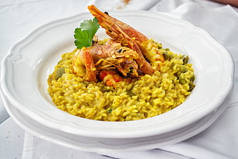 Yellow Shrimp Risotto with Prawns on White Plate