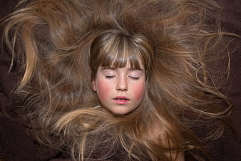 Close-up portrait of sleeping girl with long flowing hair