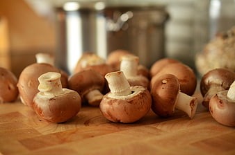 Fresh Brown Mushrooms on Wooden Cutting Board