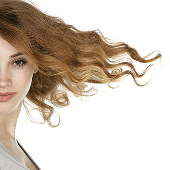 Young Woman With Windblown Hair And Freckles On White Background