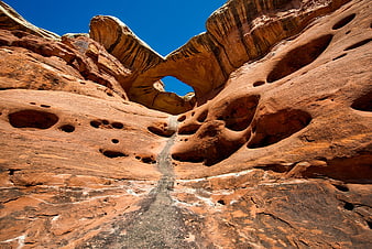 Natural sandstone arch in red rock desert landscape