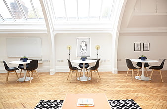 Bright modern office meeting room with skylight and parquet floor