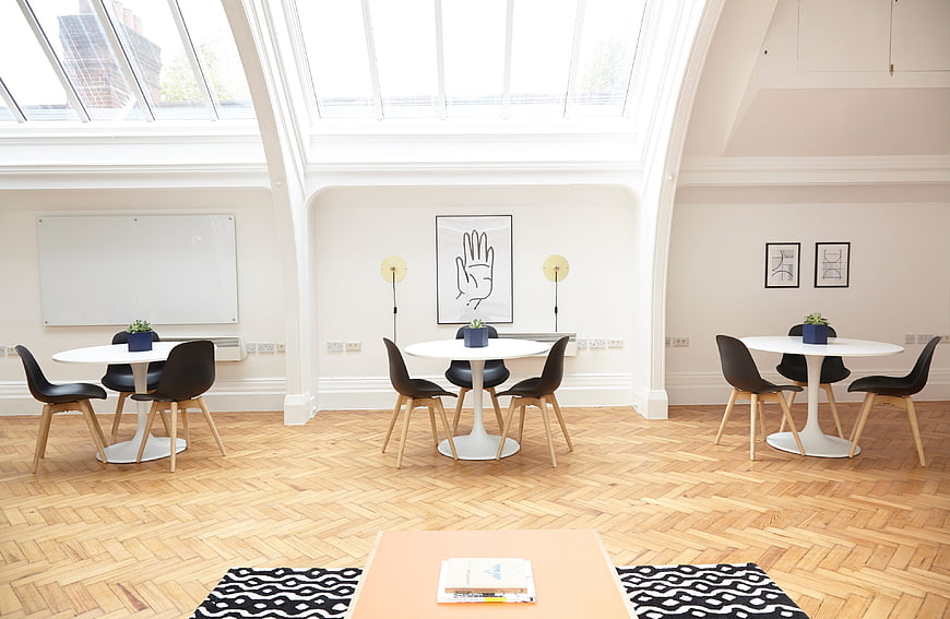 Bright modern office meeting room with skylight and parquet floor