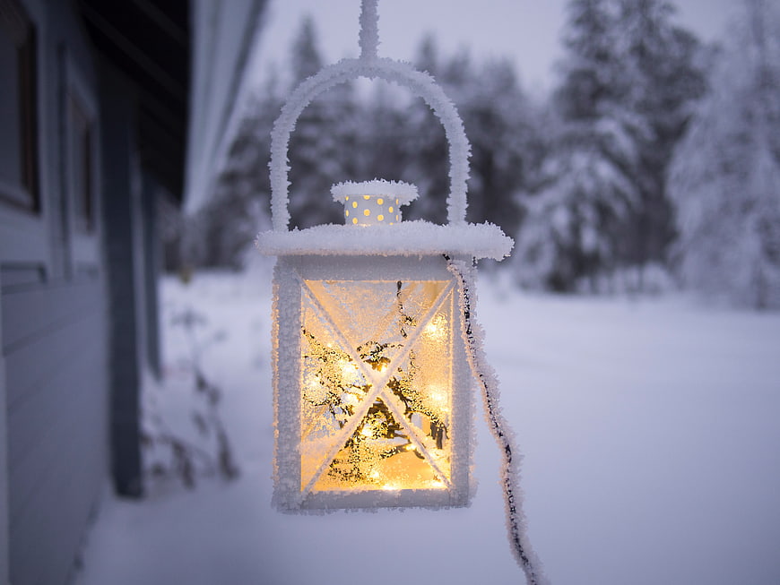 Snowy Lantern with Warm Light in Winter Landscape