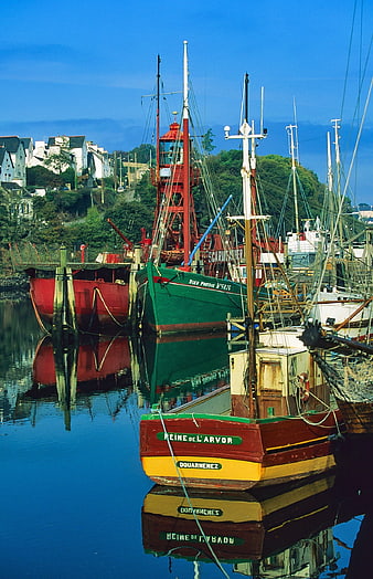 Colorful fishing boats docked in a French harbor