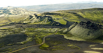 Winding dirt road through volcanic landscape in Iceland