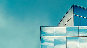 Modern Glass Building Architecture with Blue Sky Reflection