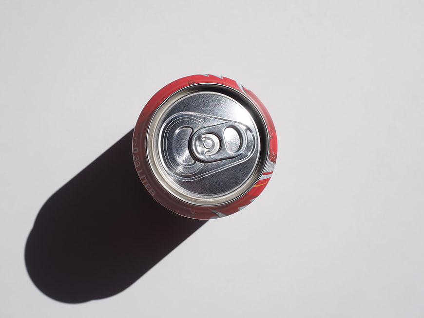 Top Down View of Red Soda Can with Hard Shadow on White Background