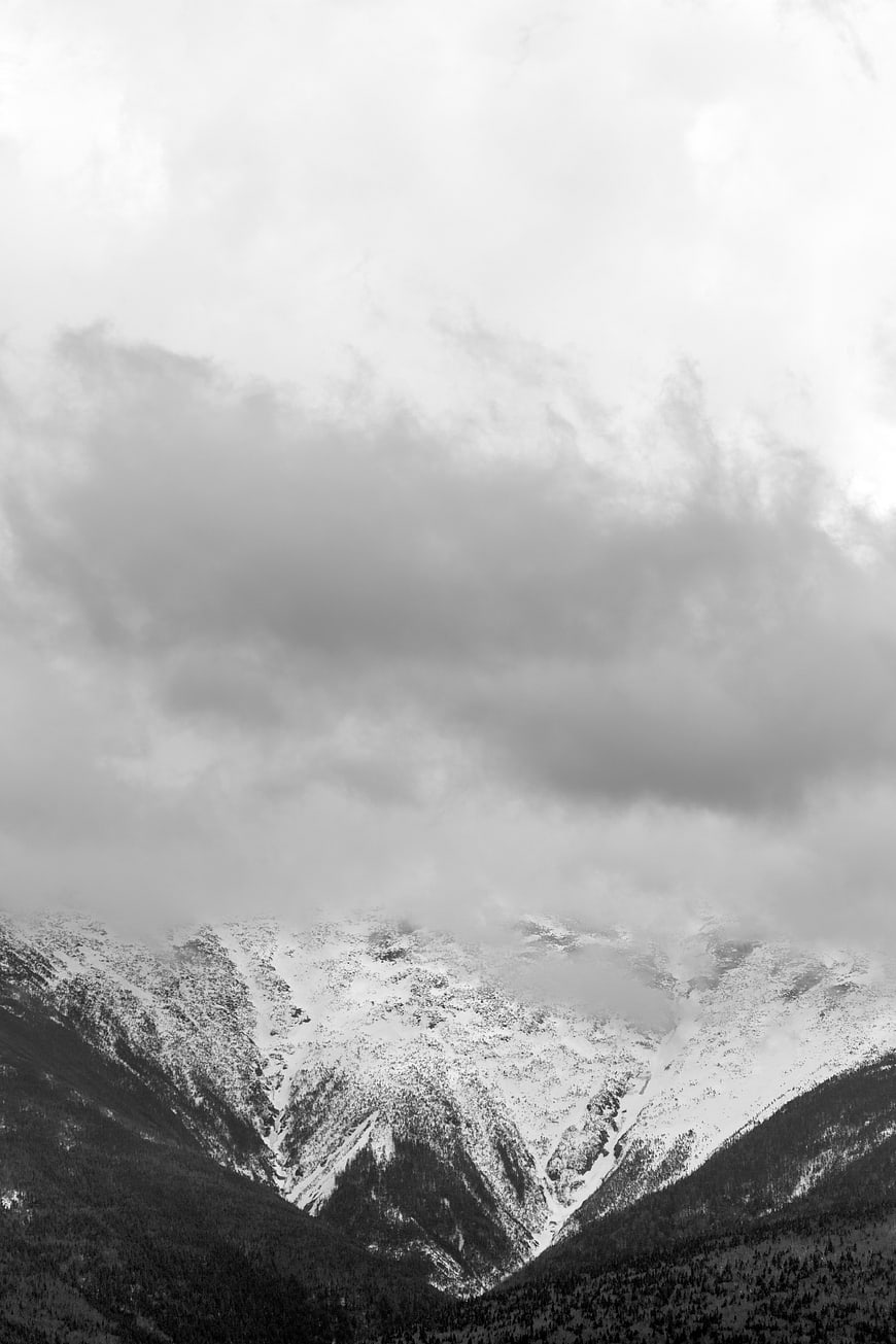 Dramatic Black and White Snowy Mountain Landscape with Clouds