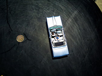 Aerial view of classic white convertible car on dark asphalt