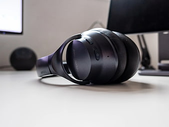 Black Wireless Headphones on White Desk