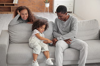 Happy African American Family Playing Together on Sofa