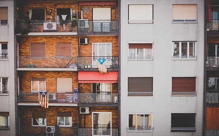 Urban apartment facade with balconies and flags
