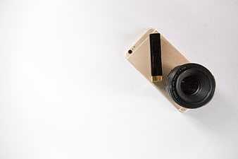 Minimal Smartphone with Camera Lens and Lipstick on White Background