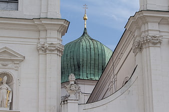 Green copper dome of Passau Cathedral framed by white architecture