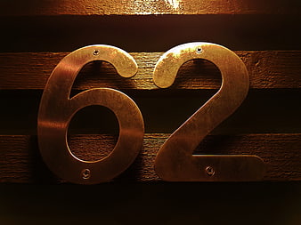 Vintage Brass House Number 62 on Wooden Planks