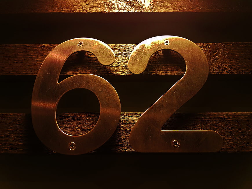 Vintage Brass House Number 62 on Wooden Planks