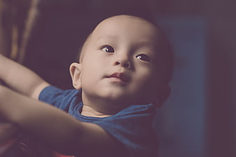 Close-up portrait of cute baby boy looking up