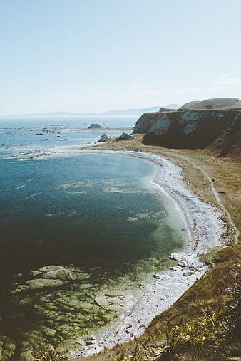 Scenic coastal landscape with clear turquoise water and cliffs