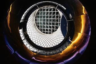 Abstract architectural view of a modern glass atrium with golden reflections