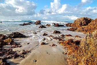 Rugged Rocky Beach with Crashing Waves and Blue Sky