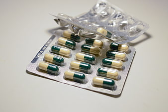 Unsealed Blister Pack Of Green And White Medicine Capsules