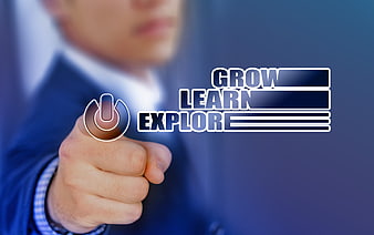 Businessman touching digital power button with grow learn explore text