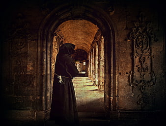 Hooded Monk Standing in Ancient Stone Cloister Corridor