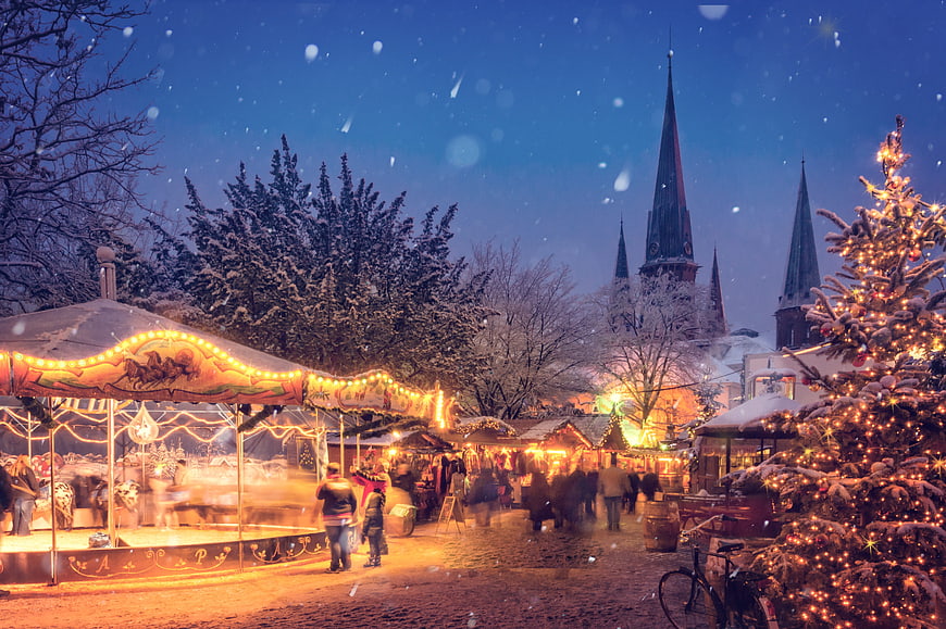 Magical Christmas Market with Carousel and Church at Dusk