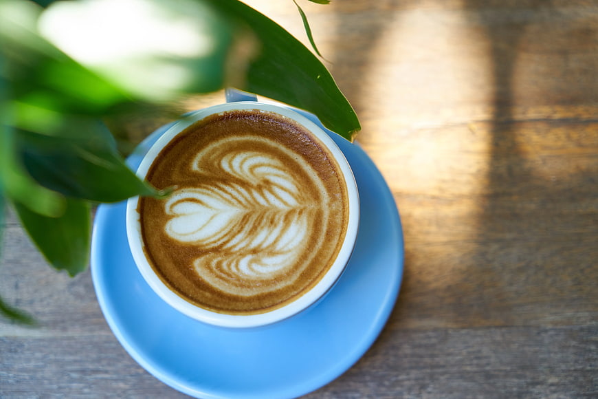 Top View of Latte Art in Blue Cup on Wooden Table