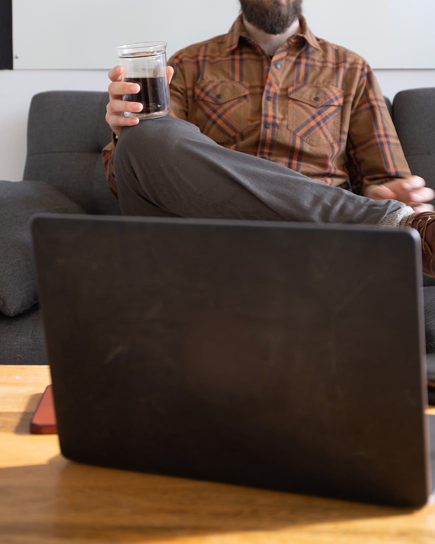 Man with Coffee and Laptop on Couch