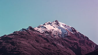 Snow-Capped Mountain Peak with Pink and Purple Hues