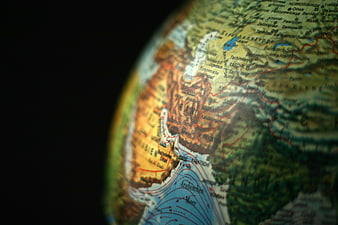 Close-up of a globe map showing Iran, Afghanistan, and Central Asia