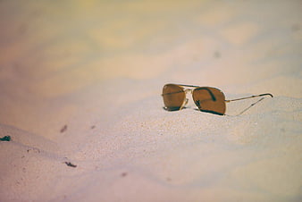 Aviator Sunglasses Resting on Sandy Beach Dunes