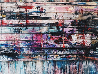 Abstract colorful graffiti art on weathered wooden planks