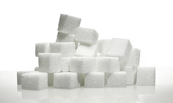 Stack of white sugar cubes on a white background