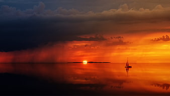 Silhouette of Sailboat on Calm Sea at Dramatic Sunset