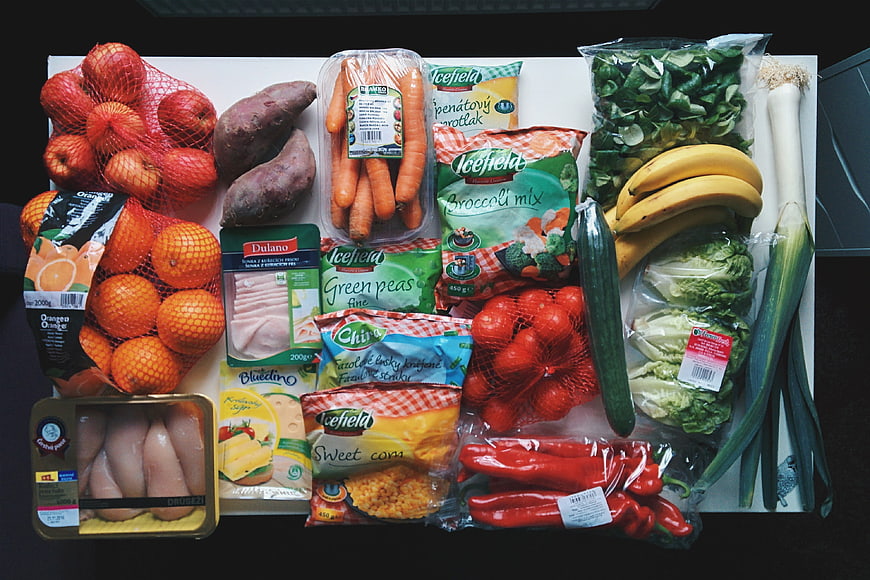 Top view of healthy grocery haul with fresh vegetables and fruits