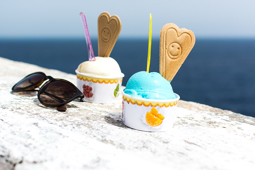 Blue and white ice cream cups with wafers by the sea