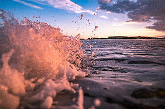 Ocean Wave Splash at Sunset with Golden Hour Light