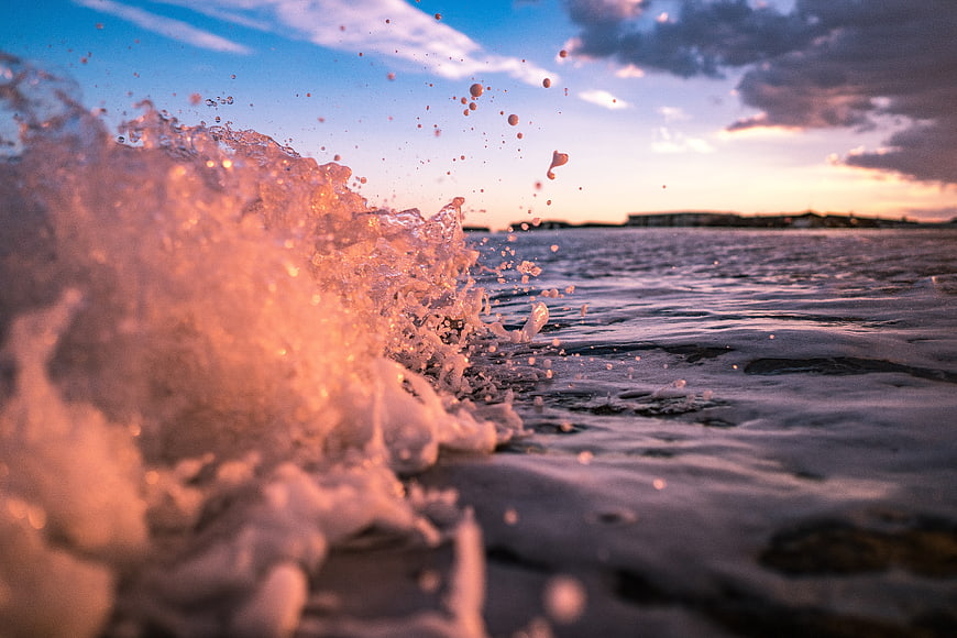 Ocean Wave Splash at Sunset with Golden Hour Light