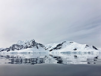 Snow-Capped Mountains Reflected in Calm Antarctic Waters