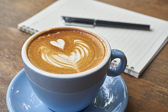 Blue Coffee Cup with Latte Art and Notebook