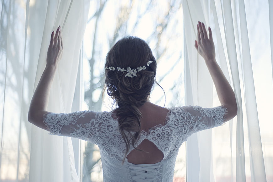 Bride in Lace Wedding Dress Opening White Curtains