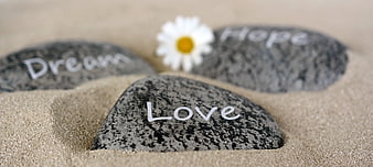 Stones with Love, Dream, and Hope on Sand
