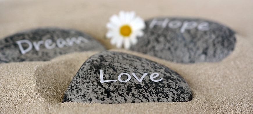 Stones with Love, Dream, and Hope on Sand