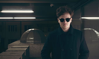 Man in Sunglasses and Coat in Urban Setting