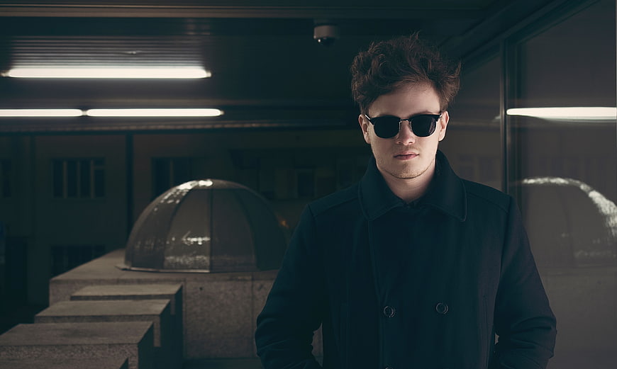 Man in Sunglasses and Coat in Urban Setting