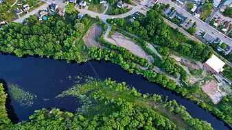 Aerial View of River, Forest, and Suburban Development