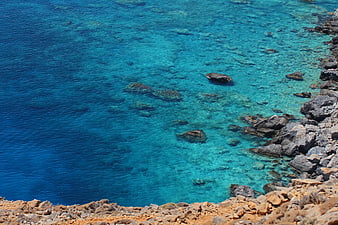 Aerial View of Turquoise Sea and Rocky Coastline